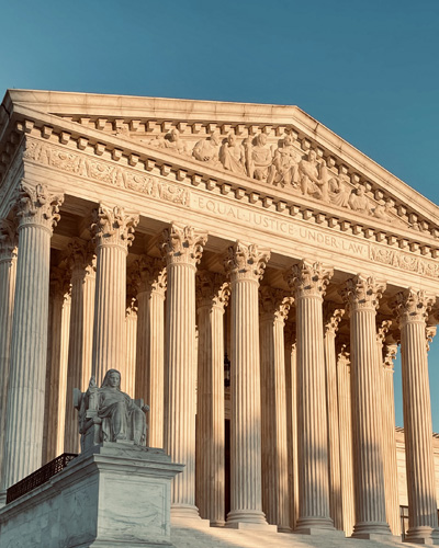 The outside of a federal courthouse at sunrise